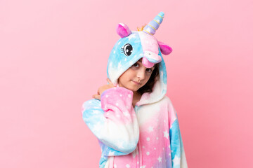Little caucasian woman wearing a unicorn pajama isolated on pink background laughing © luismolinero
