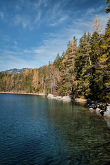 Eibsee - beautiful blue green lake in the mountains with forest in the background