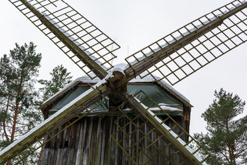 Zemgale windmill's sails closeup. It is the older type of windmills, the so-called pole type. Windmill’s place of origin is Šķibe, Latvia, and it was built in 1814 (re-erected in1935). - obrazy, fototapety, plakaty