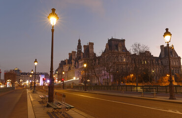 The City Hall of Paris and bridge Arcole across Seine river at night, Paris.