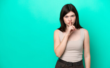 Young Russian woman isolated on green background showing a sign of silence gesture putting finger...