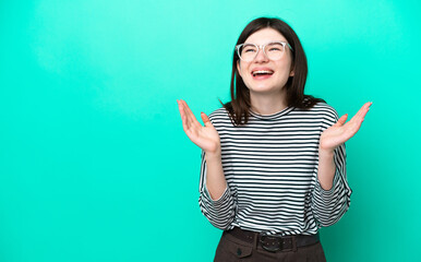 Young Russian woman isolated on green background smiling a lot