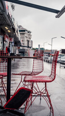 Pet cups and red chairs on the table