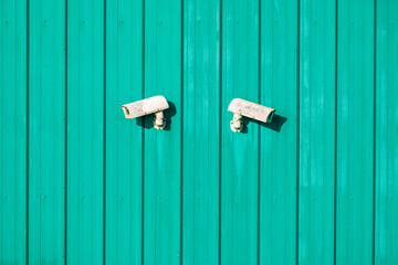 cctv security camera on a green wooden background