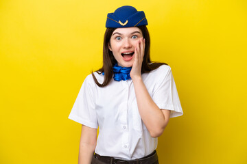 Airplane stewardess Russian woman isolated on yellow background with surprise and shocked facial expression