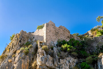 Fototapeta na wymiar ruins of fortress walls on rocky mountain slopes near the antique city of Olympos, Turkey