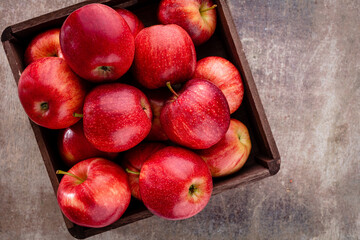 Ripe red apples in wooden box. Top view with space for your text.