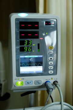 Low light picture with noise effect added of vital sign monitor used in a hospital showing low heart rate. Also showing good oxygen rate.
