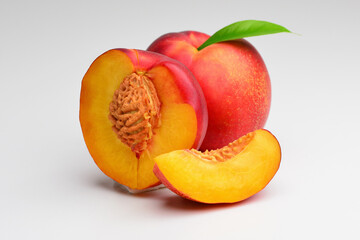 Peach fruit with peach leaf isolated on white background. Peach clipping path. Professional studio macro shooting.