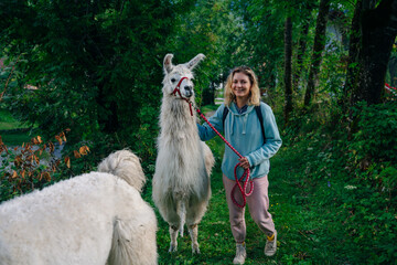 girl with a llama in the forest, italy © IBRESTER
