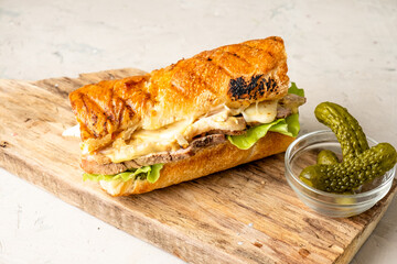 Classic Cuban pork sandwich with pickles and cheese.