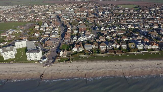 Aerial video along the seafront of East Wittering, a seaside village in Southern England and popular with tourists in the summer.