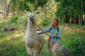 girl with a llama in the forest, italy © IBRESTER