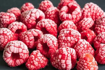 frozen red raspberries background closeup