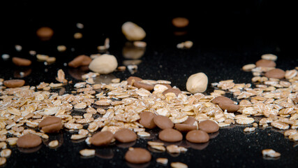 MACRO: Healthy muesli mixture gets scattered across an empty kitchen counter. - Powered by Adobe