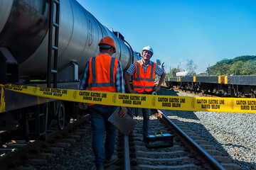 train on the railway. train on the rails. two worker checking oil tank on yard. The engineer Inspection  oil tank on rails. worker work on railway. construction, engineer, workers ,rail, Infrastructur