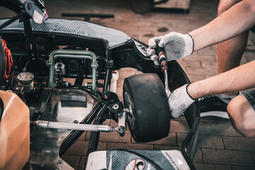 The mechanic go kart racing service change the wheels - obrazy, fototapety, plakaty