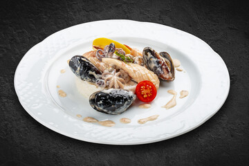 Rice with seafood: shrimp, squid and mussels. Isolated on a black background.
