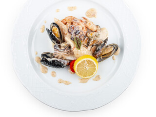 Rice with seafood: shrimp, squid and mussels. Isolated on a white background.