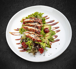 Salad with eel and avocado . Isolated on a black background.