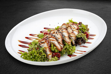 Salad with eel and avocado . Isolated on a black background.
