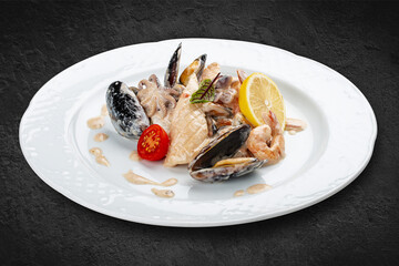 Rice with seafood: shrimp, squid and mussels. Isolated on a black background.