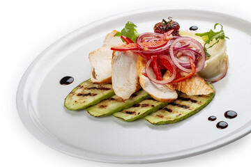 Baked chicken fillet on a pillow of mashed potatoes. Isolated on a white background.