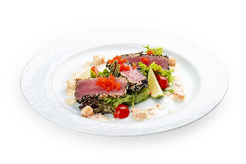 Tuna on a pillow of chuka with shrimp sauce . Isolated on a black background.