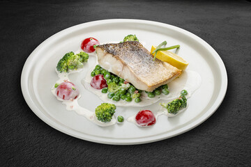 Pike perch on a vegetable pillow . Isolated on a black background.