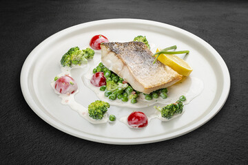 Pike perch on a vegetable pillow . Isolated on a black background.