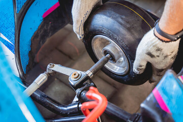 The mechanic go kart racing service change the wheels - obrazy, fototapety, plakaty
