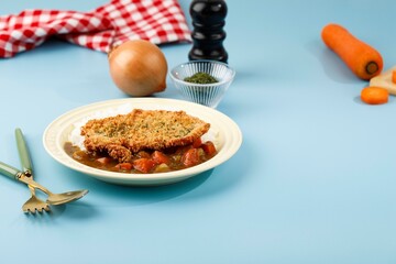 Chicken Katsu with Japanese Curry, Serve with White Rice on Cream Ceramic Plate, Blue Background