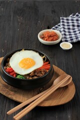 Bibimbap Rice with Mix Sautee Vegetables, Beef,  and Egg. Served with Red Spicy Bibimbap Sauce and Sesame Oil. Copy Space for Text