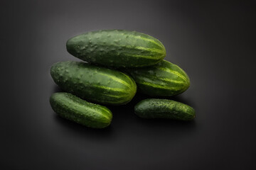 Cucumbers on a black background. Fresh cucumbers. Vegetarian food. Place for text.