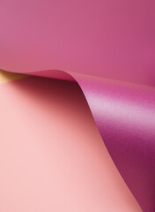 Violet wavy sheet of paper on a pastel pink background. Abstract vibrant background