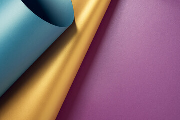 Blue, gold and violet metallic paper sheet layout forming a geometric abstract background. Minimal...