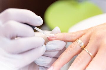 Obraz na płótnie Canvas woman receiving nail procedure in beauty salon.