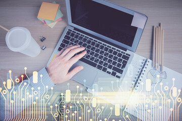 Multi exposure of man's hands typing over computer keyboard and data theme hologram drawing. Top view. Technology concept.