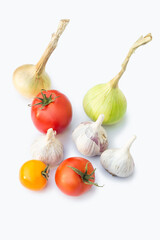 Vegetables on a white background. Garlic, tomatoes, onions. White background