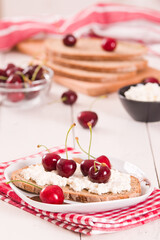 Rye bread with cottage cheese and cherries.