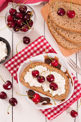 Rye bread with cottage cheese and cherries.