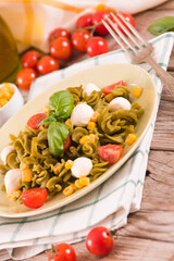 Fusilli pasta with cherry tomatoes and sweet corn.