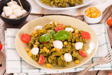 Fusilli pasta with cherry tomatoes and sweet corn.
