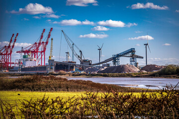Fototapeta na wymiar Cranes at Port of Liverpool - viewed from Crosby Beach