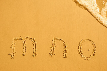 alphabet letters m n o handwritten in sand