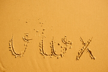 alphabet letters v w x handwritten in sand