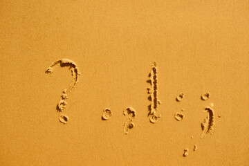 Question marks and exclamations in summer on the sand