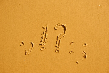 Question marks and exclamations in summer on the sand