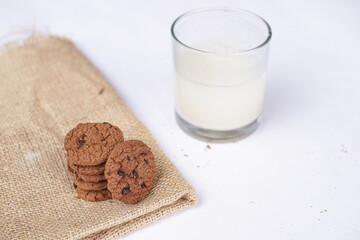 Chocolate cookies on a white table  with milk