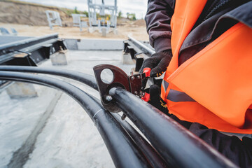 Two electrician builder workers installing high-voltage cable